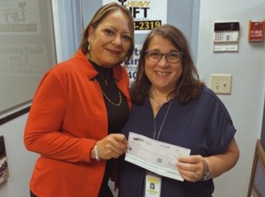 Heavy Lift Services VP Tina Dias donates $1,000 to Azure Estates