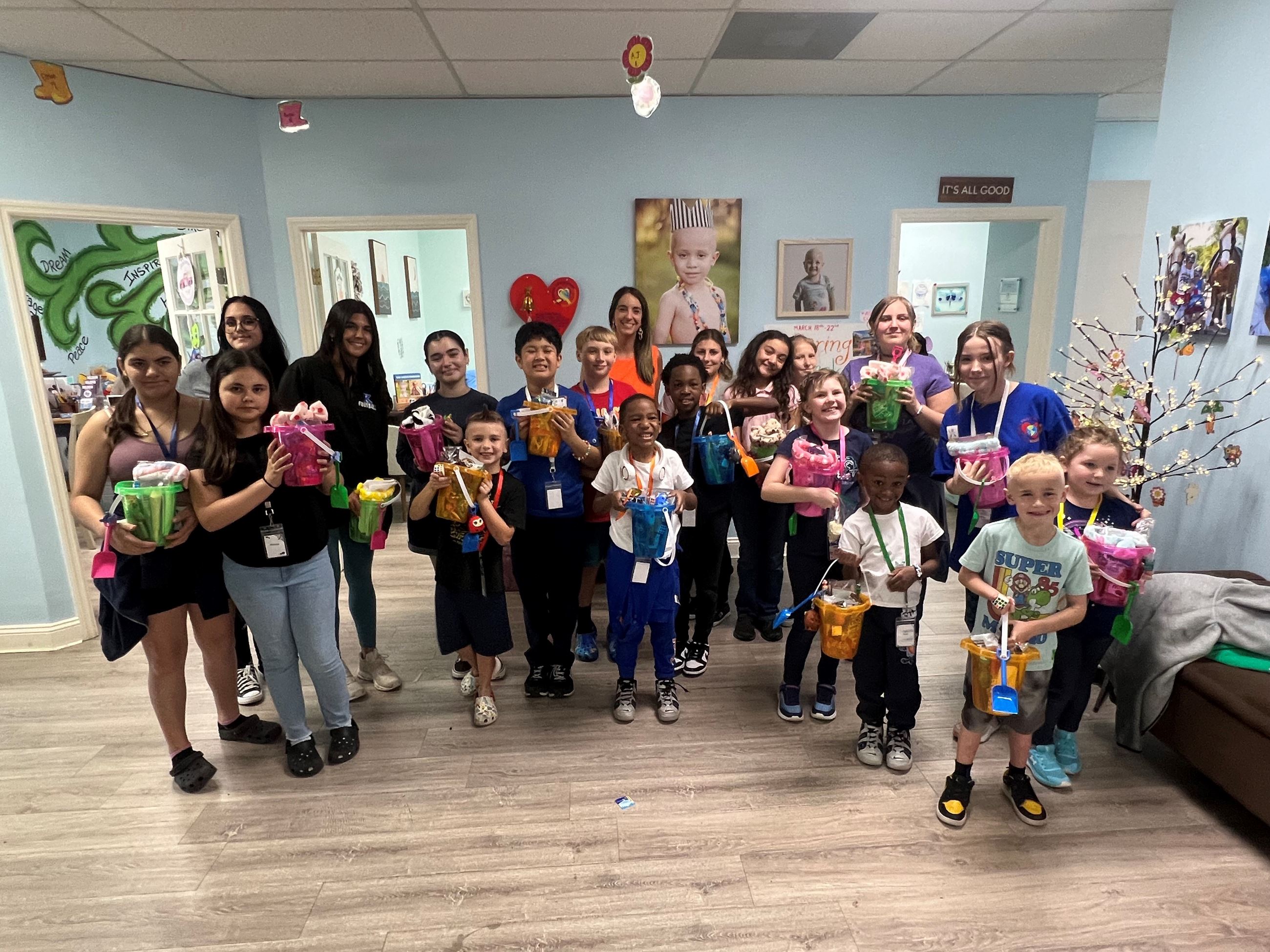 Public Information Officer Yaremi Farinas with children from the Kids Cancer Foundation