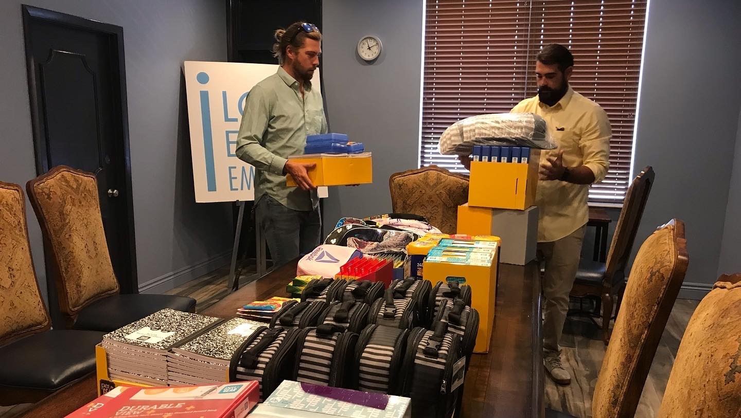 Matt Horne and Alexander Christensen donating school supplies