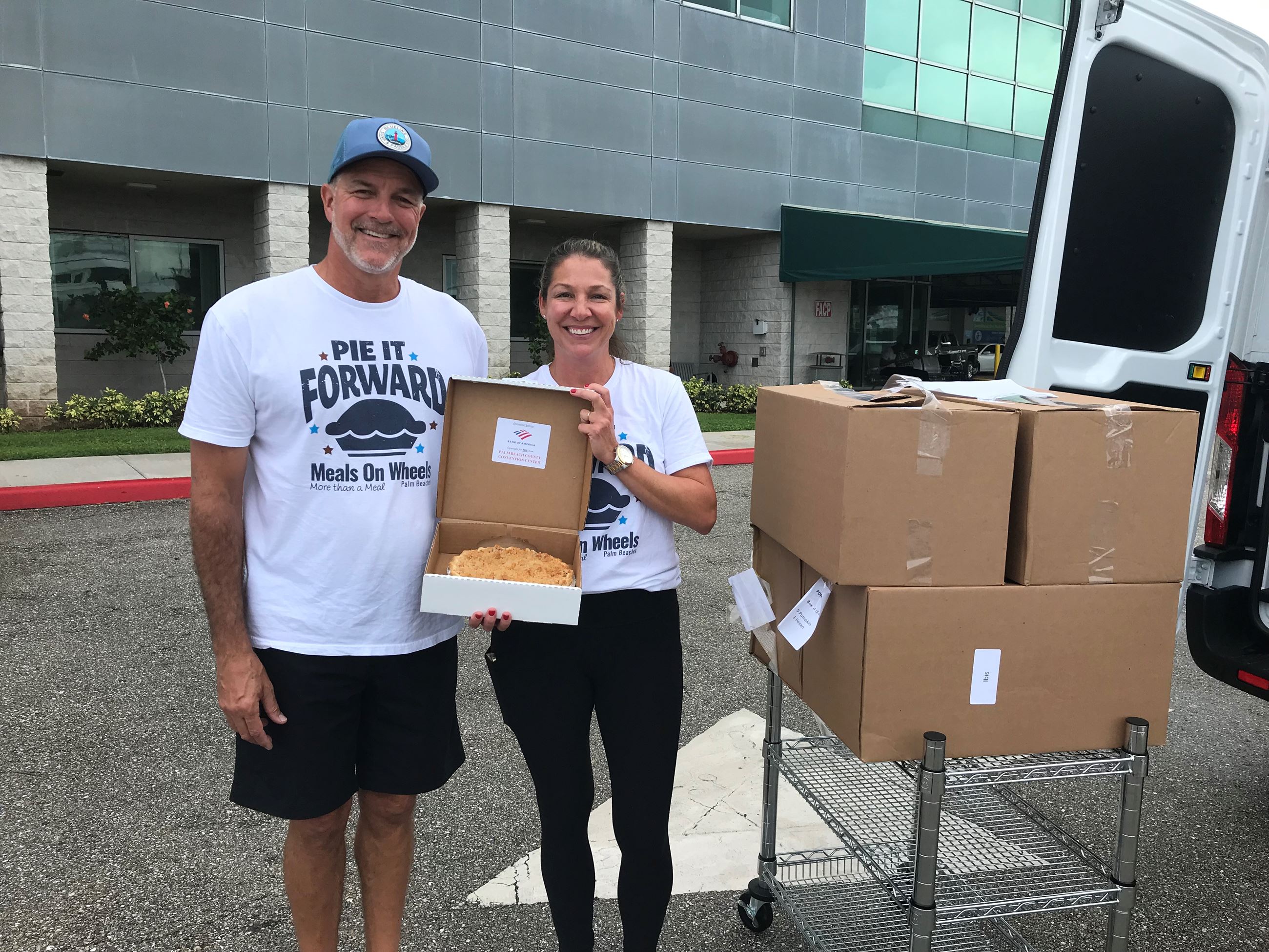Meals on Wheels representatives delivering pies